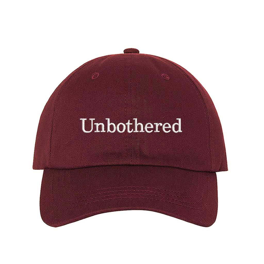 Burgundy Front view of a classic baseball hat featuring "Unbothered" in high-density script embroidery on the center crown. - DSY Lifestyle