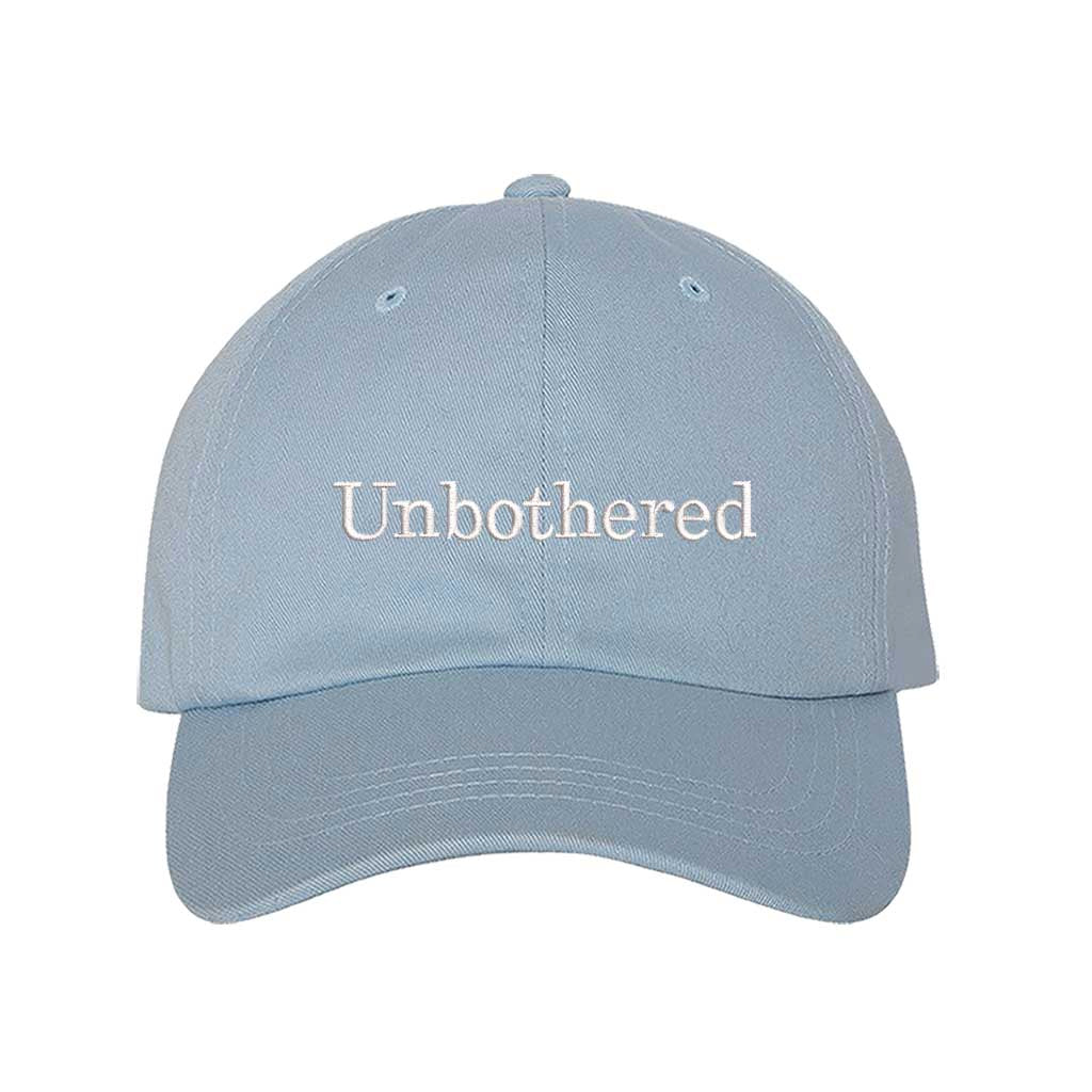 Light Blue Front view of a classic baseball hat featuring "Unbothered" in high-density script embroidery on the center crown. - DSY Lifestyle