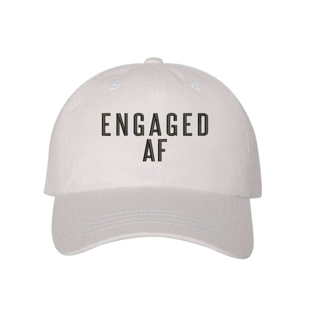 White trendy embroidered baseball hat with Engaged AF text, perfect for newly engaged brides-to-be celebrating their upcoming wedding - DSY Lifestyle