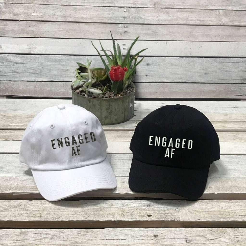 One Black and one White set of trendy embroidered baseball hats with Engaged AF text, perfect for newly engaged brides-to-be celebrating their upcoming wedding - DSY Lifestyle