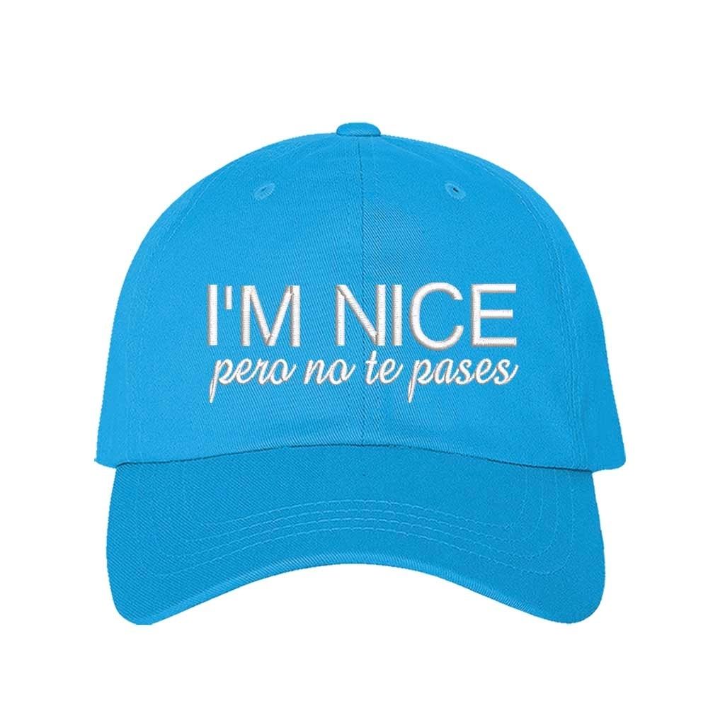 Aqua I’m Nice Pero No Te Pases Embroidered Baseball Hat in soft cotton with curved brim and hook and loop closure. DSY Lifestyle.