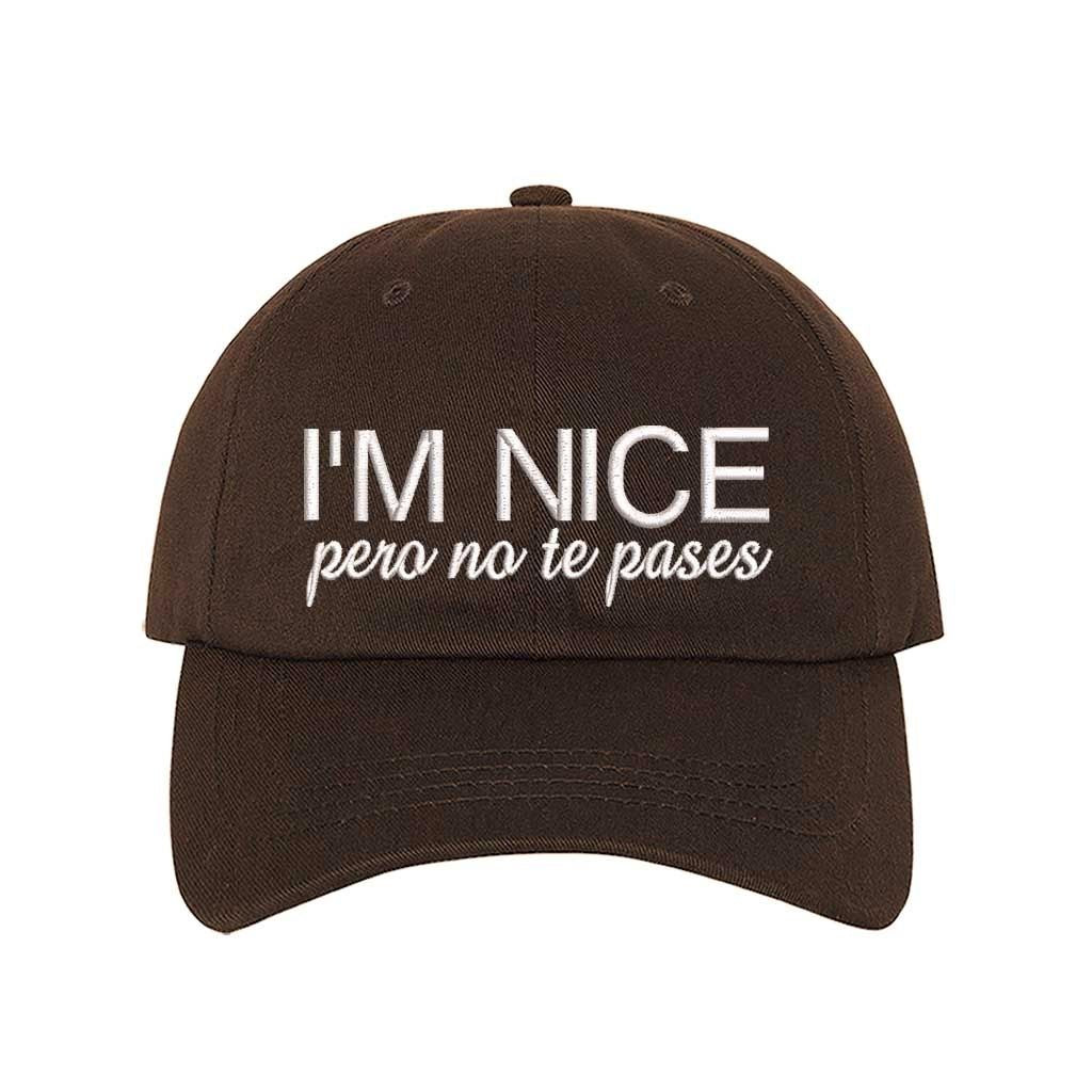Brown I’m Nice Pero No Te Pases Embroidered Baseball Hat in soft cotton with curved brim and hook and loop closure. DSY Lifestyle.