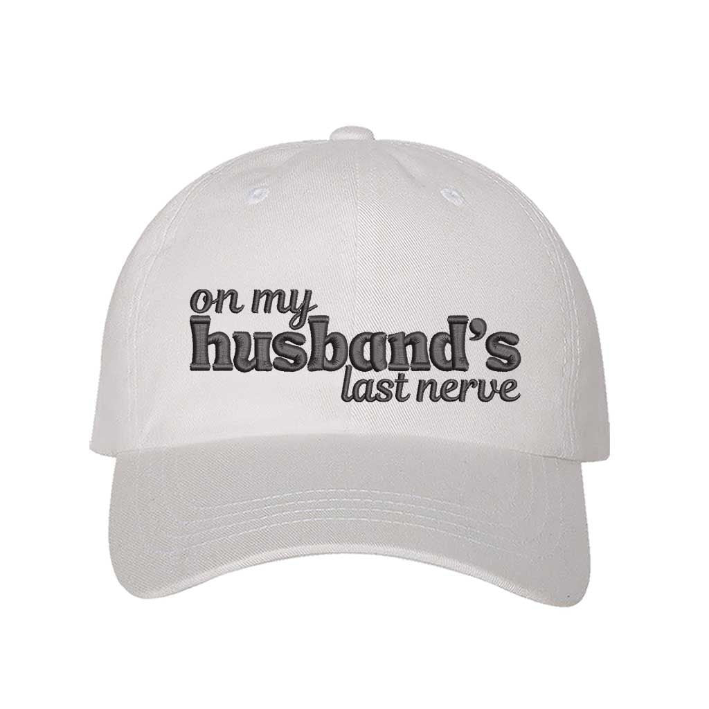 White On My Husband’s Last Nerve Embroidered Baseball Hat in cotton with curved brim and adjustable strap closure. DSY Lifestyle.