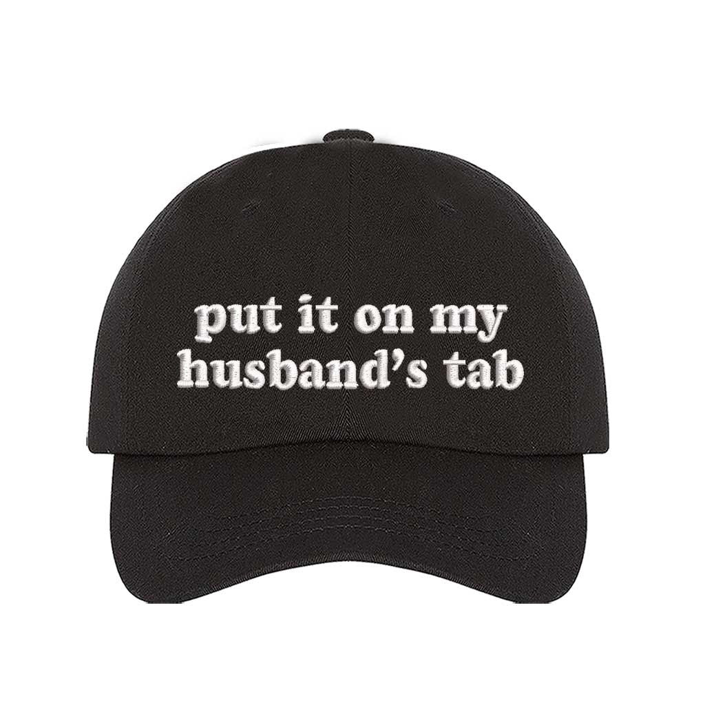 Black Put It on My Husband’s Tab Embroidered Baseball Hat in soft cotton with curved brim and adjustable back strap, perfect for vacations and girls’ nights. DSY Lifestyle.