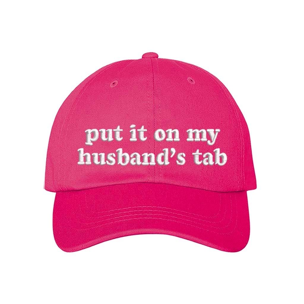 Hot Pink Put It on My Husband’s Tab Embroidered Baseball Hat in soft cotton with curved brim and adjustable back strap, perfect for vacations and girls’ nights. DSY Lifestyle.