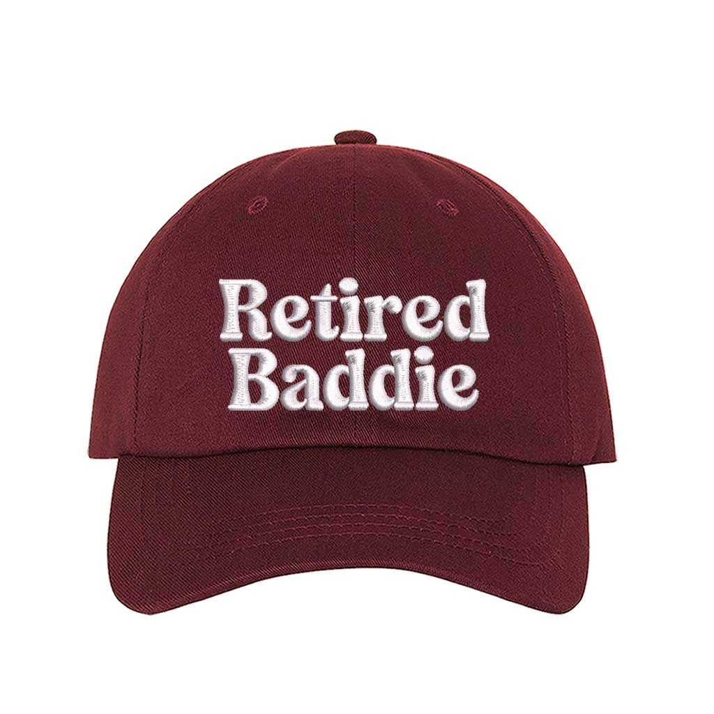 Burgundy Retired Baddie Embroidered Baseball Hat with curved brim and adjustable strap, styled for casual everyday wear. – DSY Lifestyle.