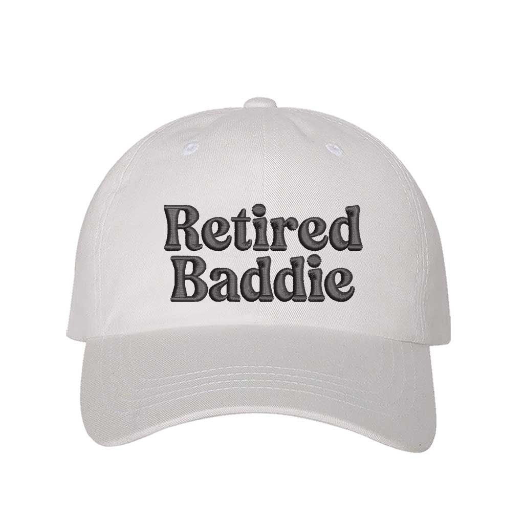 White Retired Baddie Embroidered Baseball Hat with curved brim and adjustable strap, styled for casual everyday wear. – DSY Lifestyle.