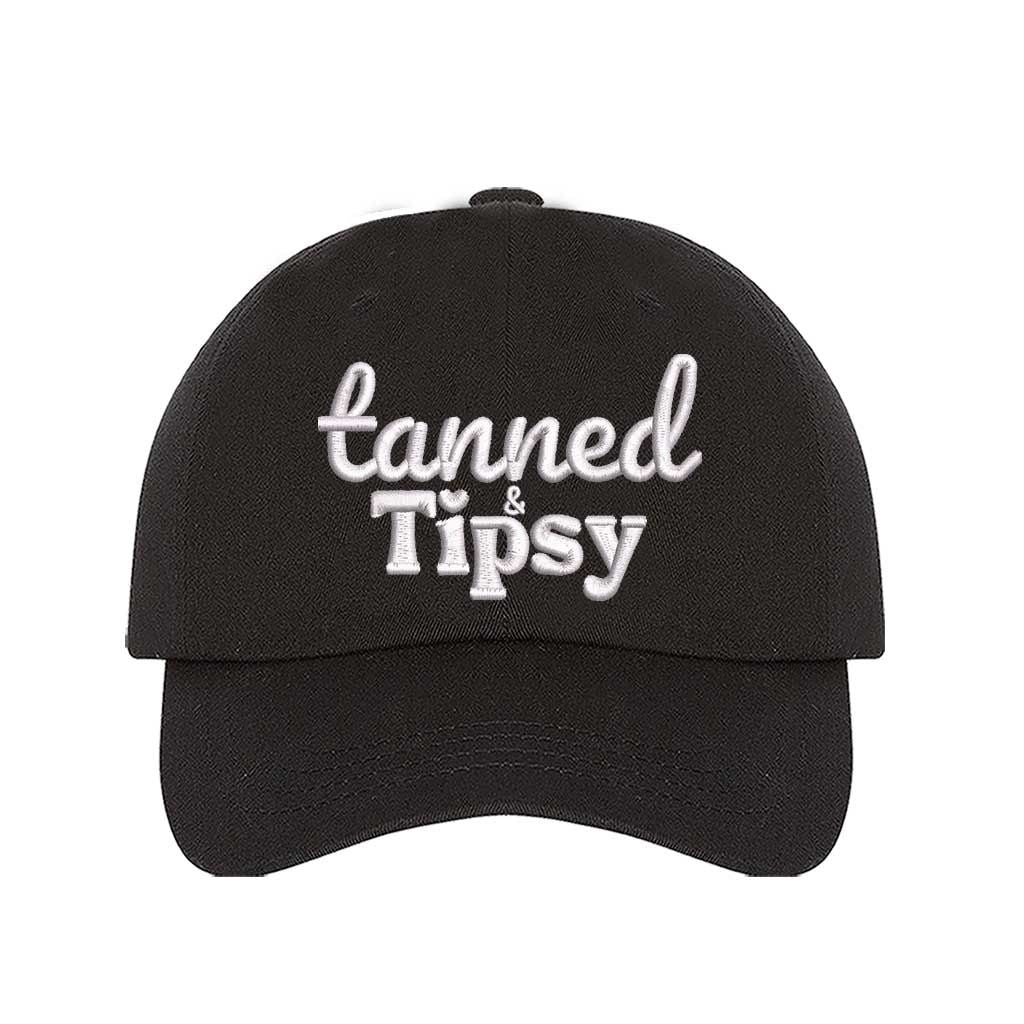 Black Tanned and Tipsy Embroidered Baseball Hat in classic cotton with pre-curved brim and hook and loop closure, perfect for beach days and summer drinks. DSY Lifestyle.