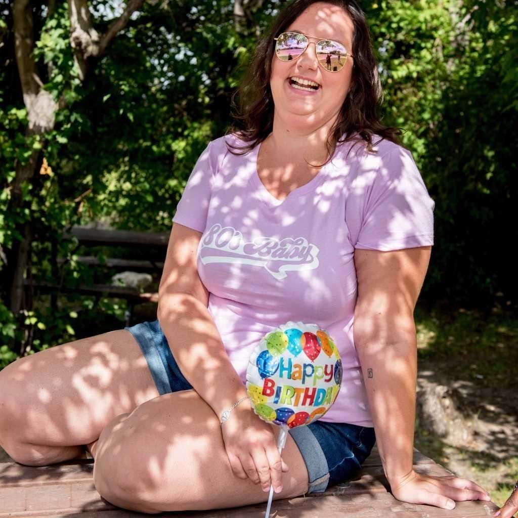 Female posing with a Lilac Unisex T-shirt with 80&