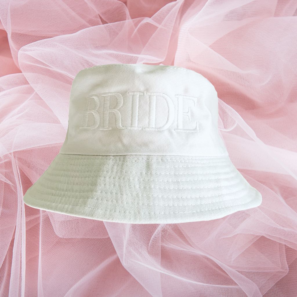 Flat lay of white bucket hat embroidered with Bride in white thread - DSY Lifestyle