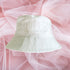 Flat lay of white bucket hat embroidered with Bride in white thread - DSY Lifestyle