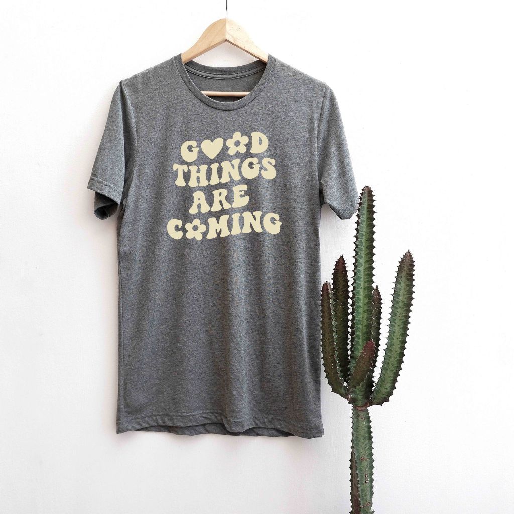 Male wearing a brown tshirt printed with Good Things are coming - DSY Lifestyle