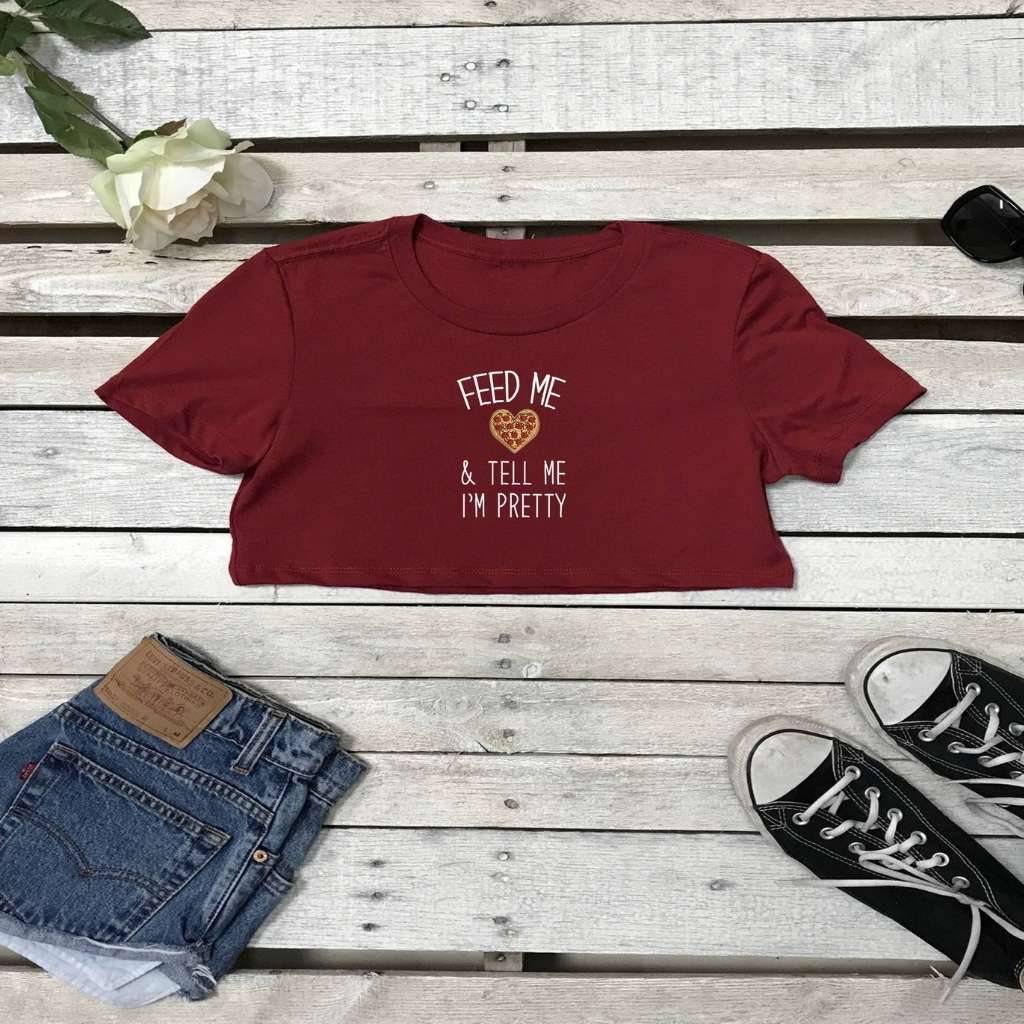 Flat lay of cardinal underboob top with feed me pizza and call me pretty printed on the front in white - DSY Lifestyle