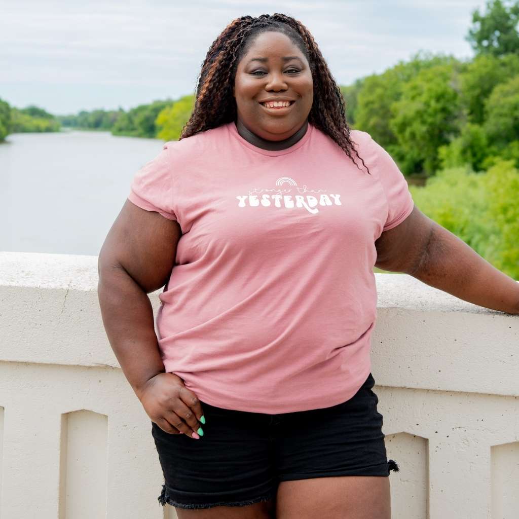 Female wearing a mauve unisex tshirt with Stronger than Yesterday - DSY Lifestyle