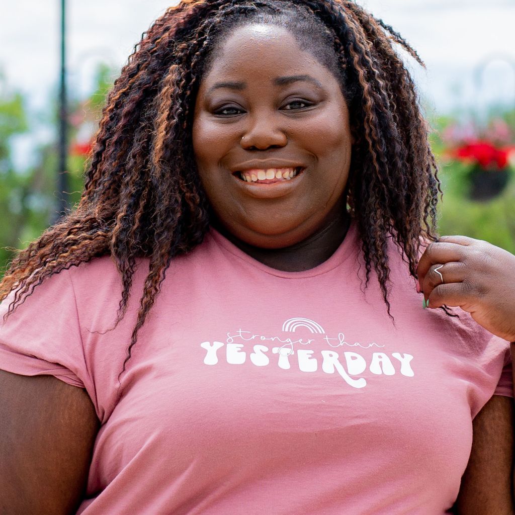 Female wearing a mauve unisex tshirt with Stronger than Yesterday - DSY Lifestyle