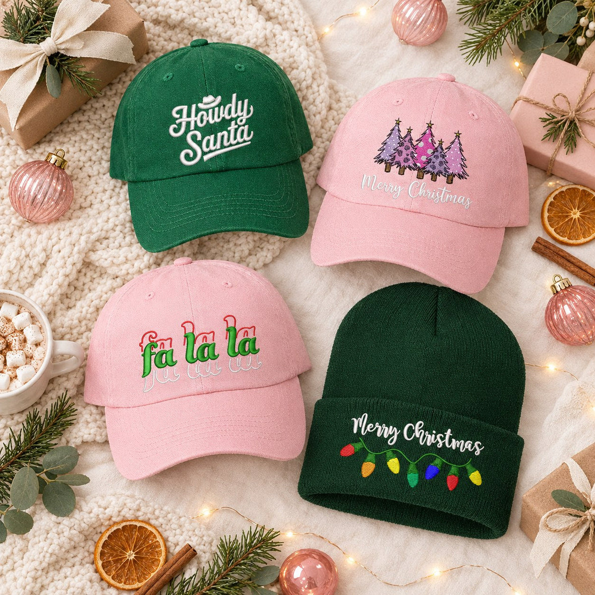 Flat lay of DSY embroidered Christmas hats and beanies: Howdy Santa, pink Merry Christmas trees, Fa La La and a Merry Christmas lights beanie with wrapped gifts, cocoa and ornaments