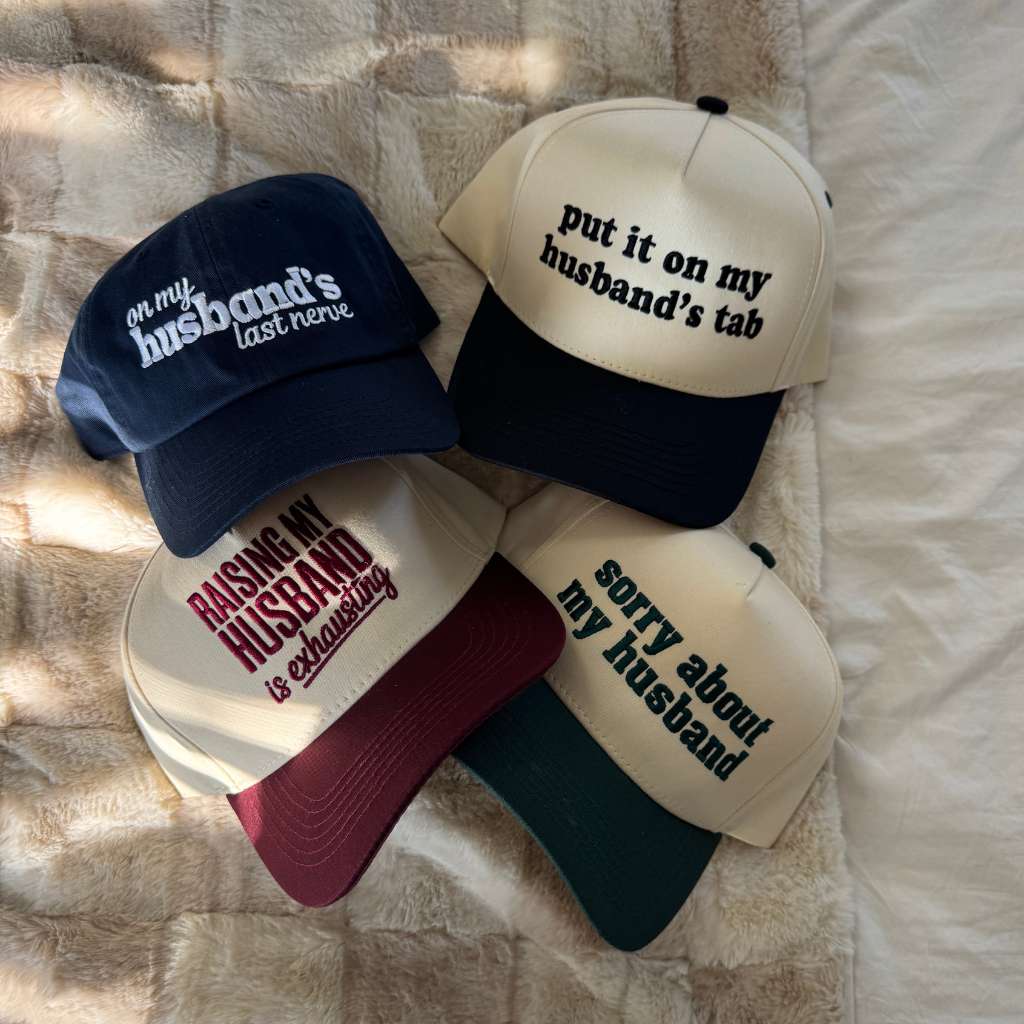 Funny hats for wifes like put it on my husbands tab, raising my husband is exhausting, and sorry about my husband embroidered by DSY Lifestyle