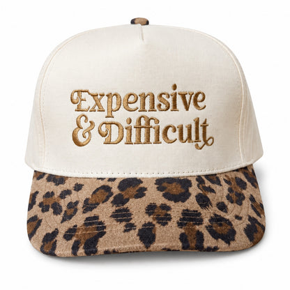 Natural five-panel trucker hat with a leopard bill and Expensive and Difficult embroidered in gold