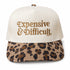 Natural five-panel trucker hat with a leopard bill and Expensive and Difficult embroidered in gold