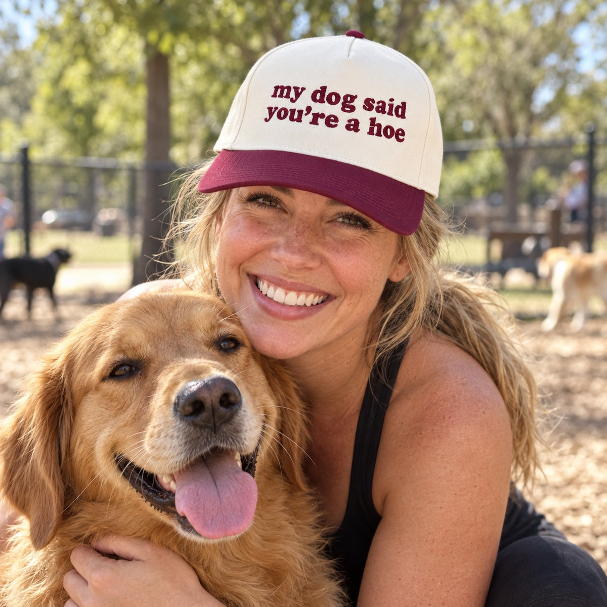 Woman hugging a golden retriever at a dog park wearing the My Dog Said You&