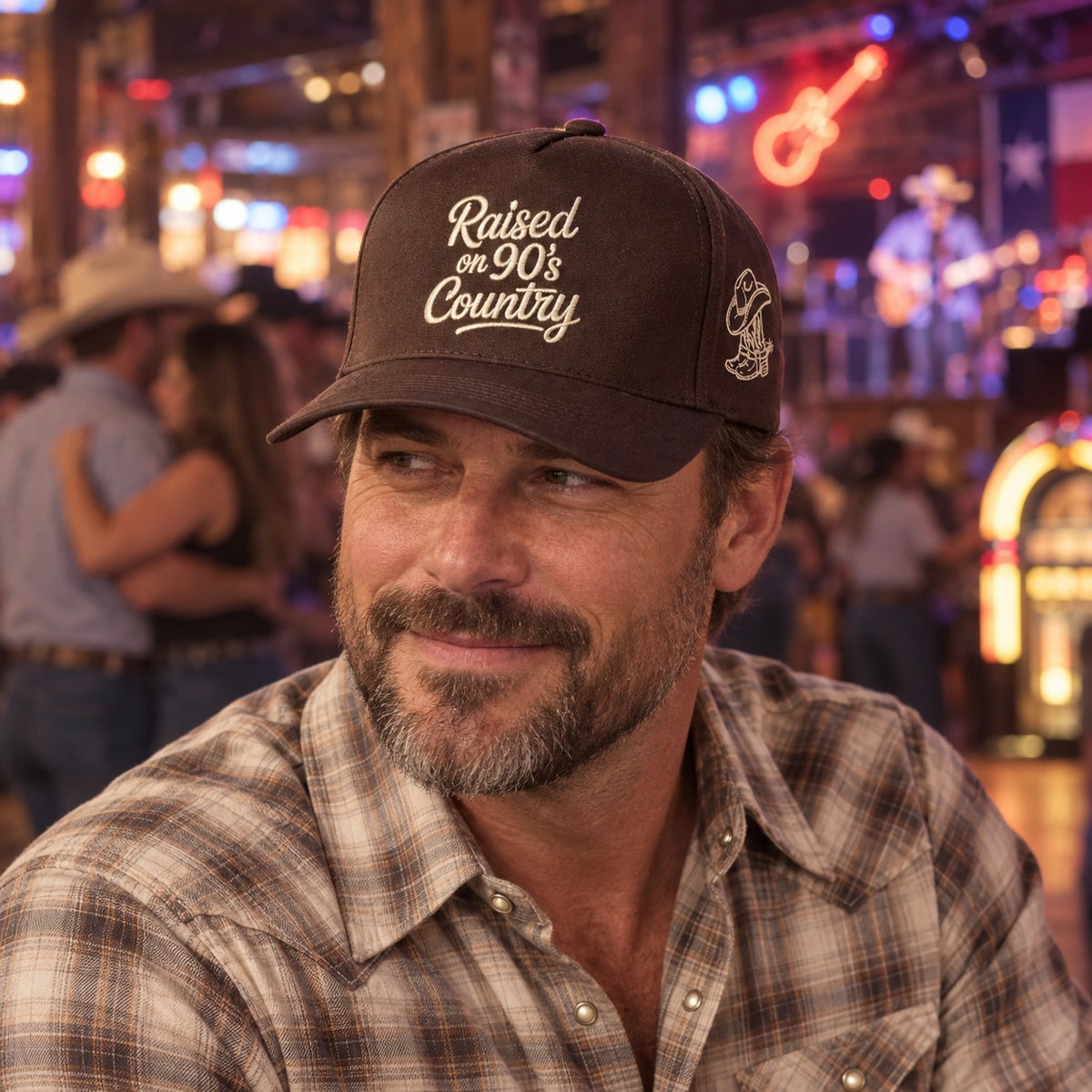 Man on a honky-tonk dance floor wearing the Raised on 90&