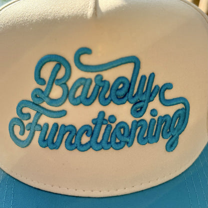 Close-up of the raised aqua 3D puff Barely Functioning lettering