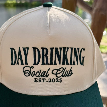 Close-up of the forest green embroidered lettering on the front of the Day Drinking Social Club trucker hat