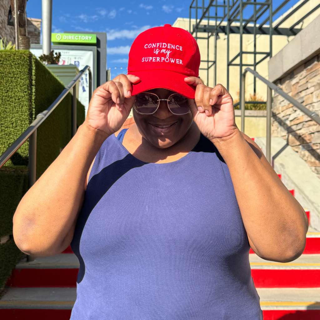 Red Confidence Is My Superpower Embroidered Baseball Hat – A bold statement hat with premium embroidery, styled with blue tank top perfect for those who own their confidence – DSY Lifestyle