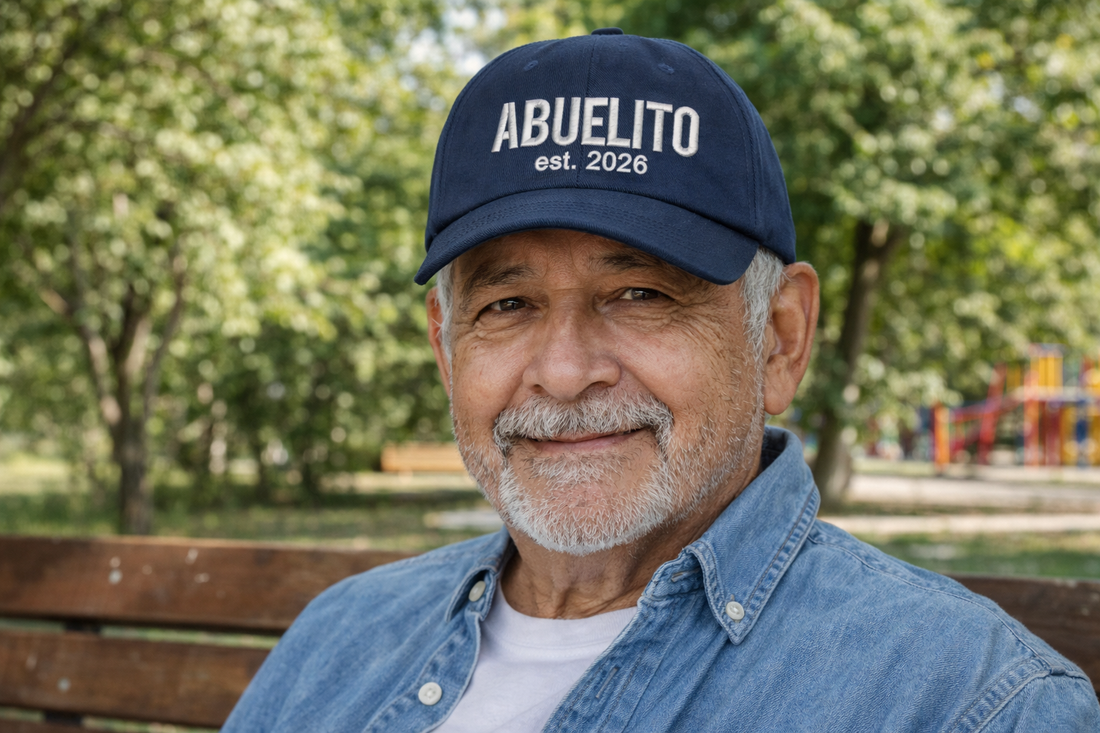 Handsome man wearing Navy Blue Abuelito Est. 2026 Baseball Hat featuring clean white embroidery on a classic navy dad cap; a thoughtful 2026 pregnancy announcement gift for a new grandpa by DSY Lifestyle.