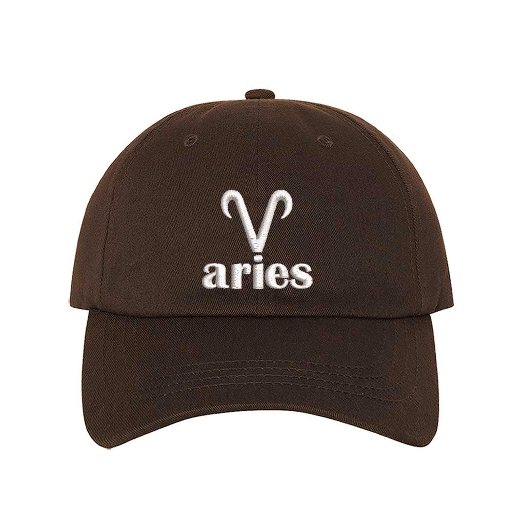 Brown Aries Symbol Embroidered Baseball Hat featuring a sharp white embroidered Ram glyph on a premium cotton crown; a minimalist zodiac statement by DSY Lifestyle.