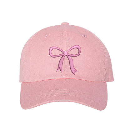 Light Pink Bow Baseball Hat featuring a dainty pink embroidered bow on a classic cap, perfect for a coquette-style outfit or a feminine statement accessory.