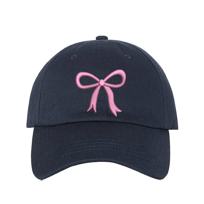 Navy Blue Bow Baseball Hat featuring a dainty pink embroidered bow on a classic cap, perfect for a coquette-style outfit or a feminine statement accessory.