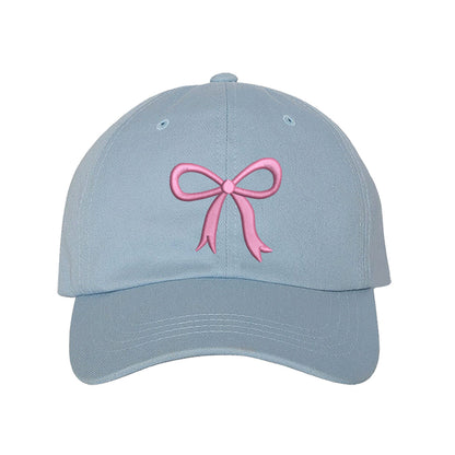Sky Blue Bow Baseball Hat featuring a dainty pink embroidered bow on a classic cap, perfect for a coquette-style outfit or a feminine statement accessory.