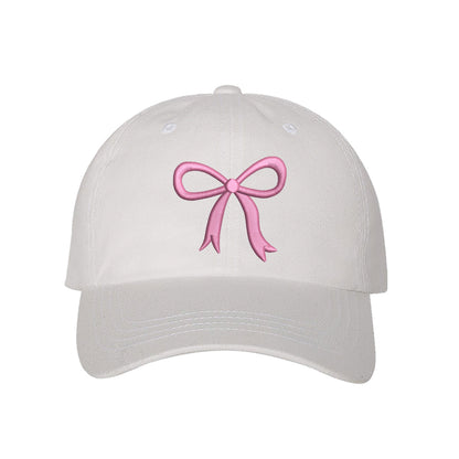 White Bow Baseball Hat featuring a dainty pink embroidered bow on a classic cap, perfect for a coquette-style outfit or a feminine statement accessory.