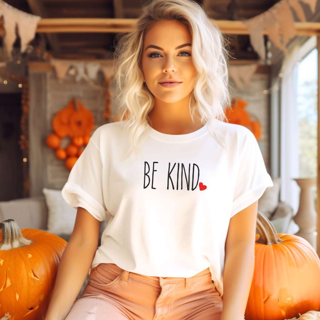 Female wearing a white oversized unisex t-shirt embroidered with Be Kind and a heart - DSY Lifestyle