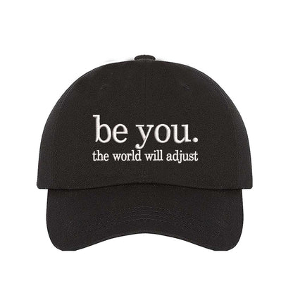 Black Be You The World Will Adjust embroidered baseball hat featuring clean minimalist typography and professional stitching by DSY Lifestyle.