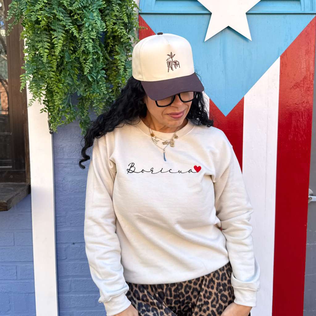 Woman wearing  a embroidered Boricua Sweatshirt with a DTMF Bad Bunny Inspired Baseball Hat = DSY Lifestyle