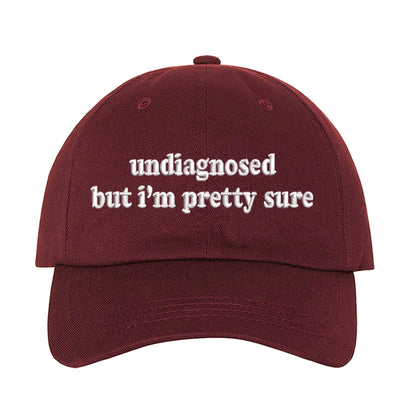 Burgundy baseball hat embroidered with the phrase undiagnosed but im pretty sure-DSY Lifestyle
