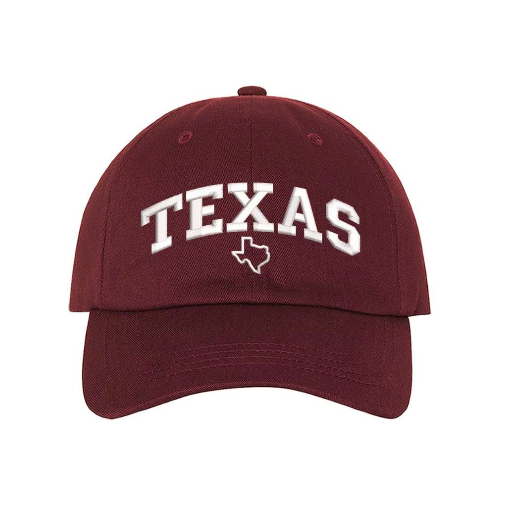Burgundy baseball hat embroidered with the word texas and a small map of texas underneath the word- DSY Lifestyle