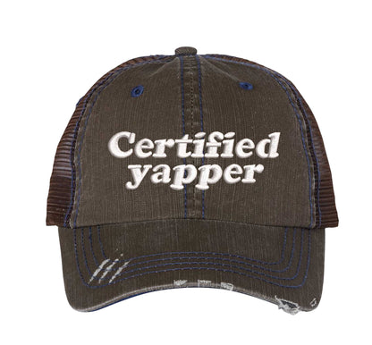 Brown DSY Lifestyle distressed trucker hat featuring the phrase Certified Yapper in bold, professional embroidery. - DSY Lifestyle