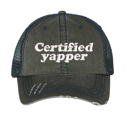 Dark Green DSY Lifestyle distressed trucker hat featuring the phrase Certified Yapper in bold, professional embroidery. - DSY Lifestyle