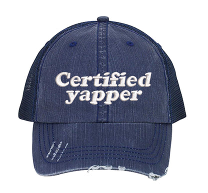Navy Blue DSY Lifestyle distressed trucker hat featuring the phrase Certified Yapper in bold, professional embroidery. - DSY Lifestyle