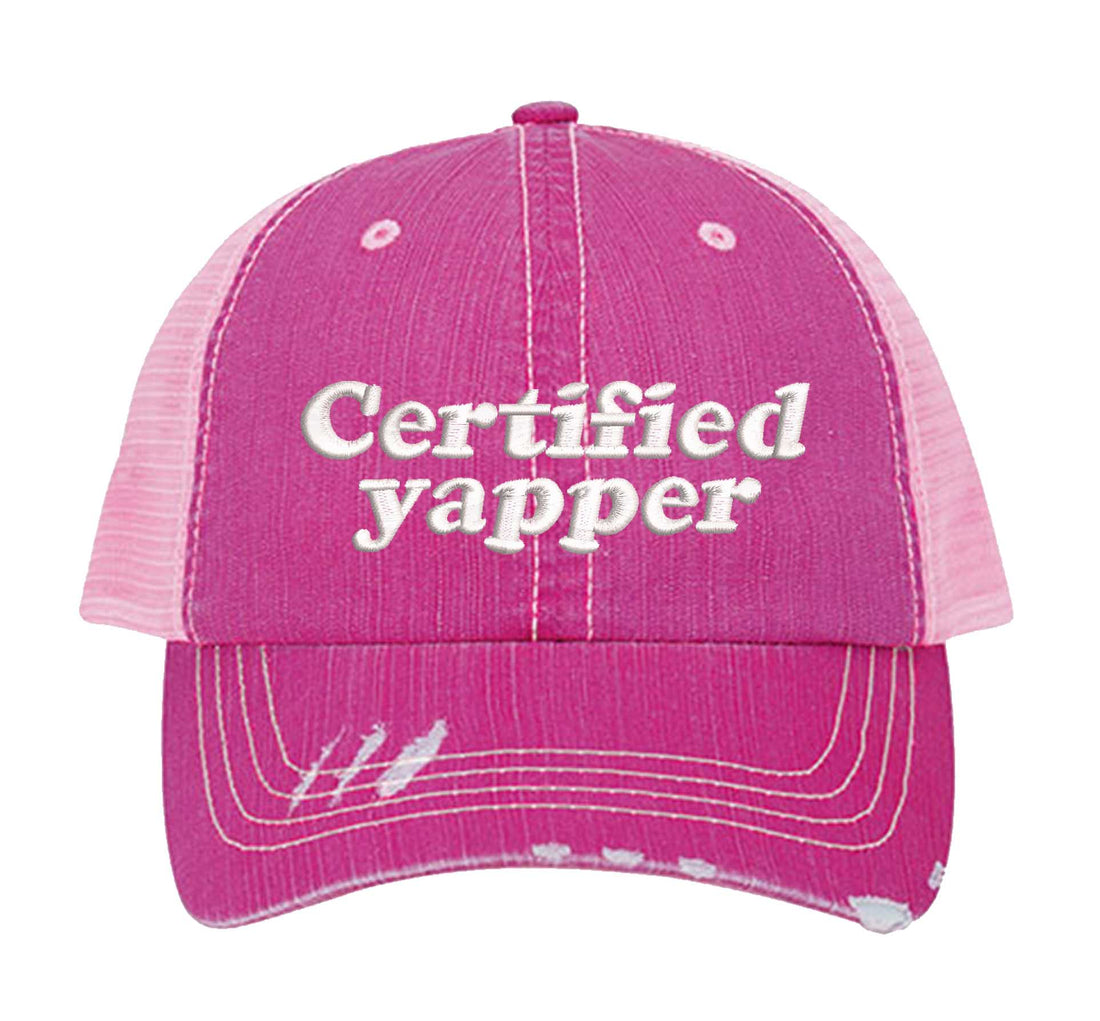 Pink DSY Lifestyle distressed trucker hat featuring the phrase Certified Yapper in bold, professional embroidery. - DSY Lifestyle
