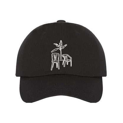 Front the DTMF Debi Tirar Mas Fotos black dad cap featuring an embroidered banana tree with two chairs, inspired by Bad Bunny&