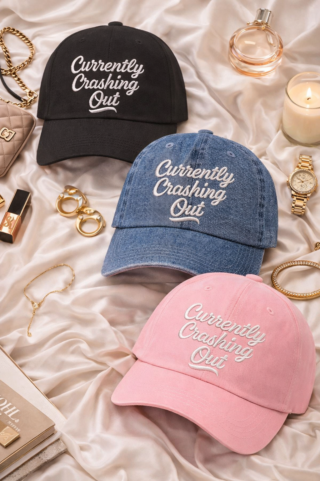 Flat lay of Black, Denim, and Pink Currently Crashing Out embroidered baseball hats. A statement baseball hat for women who love humor, comfort, and effortless everyday outfits. - DSY Lifestyle