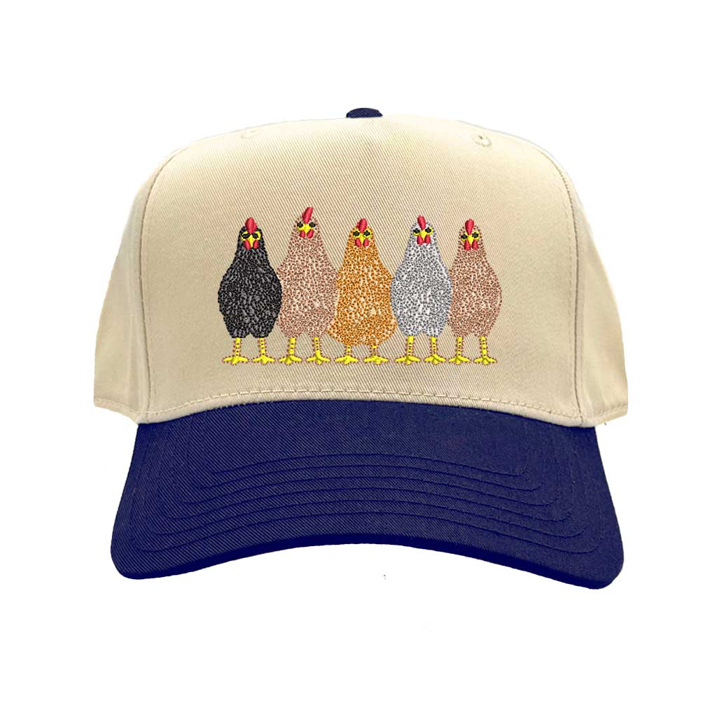 Natural Navy Blue DSY Lifestyle two-tone baseball hat with a natural-colored crown and contrasting bill, featuring an embroidered graphic of a mother hen and three small chicks. - DSY Lifestyle 