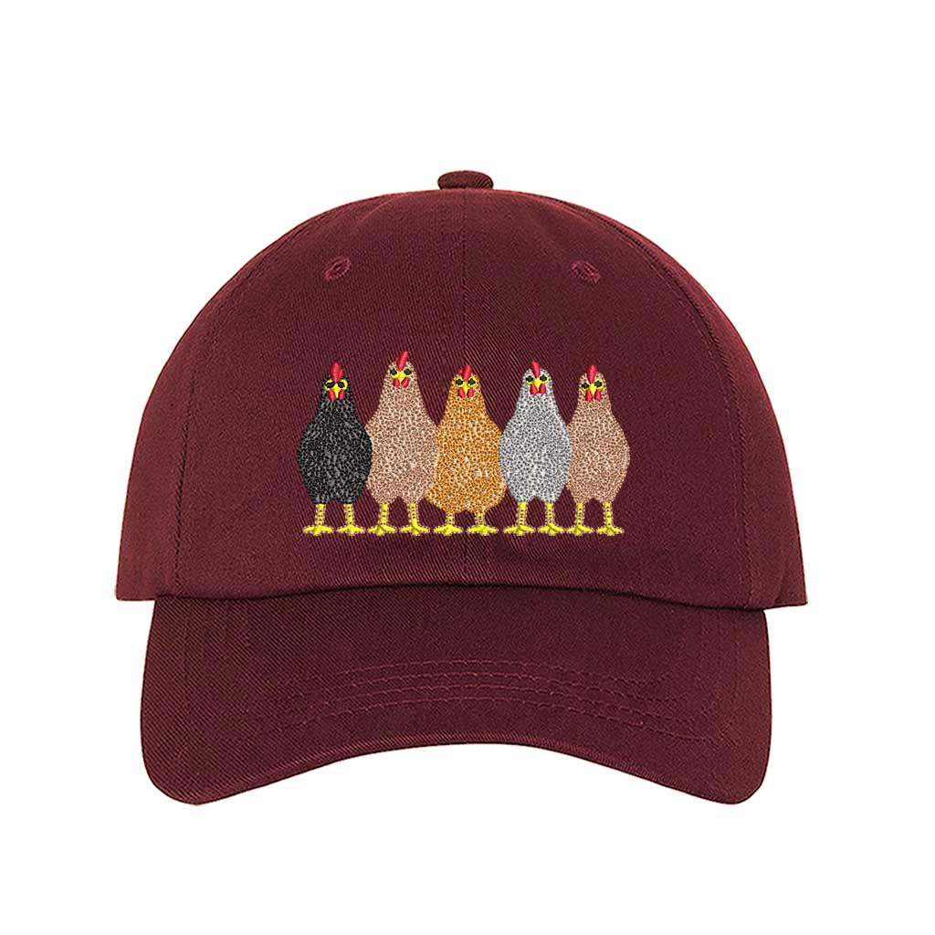 Burgundy premium DSY Lifestyle cotton baseball hat featuring a detailed embroidered graphic of a mother hen followed by a family of small chicks. - DSY Lifestyle