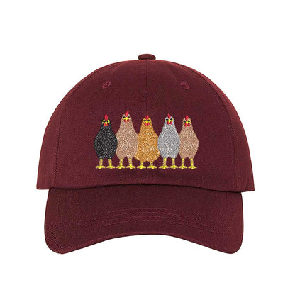 Burgundy premium DSY Lifestyle cotton baseball hat featuring a detailed embroidered graphic of a mother hen followed by a family of small chicks. - DSY Lifestyle