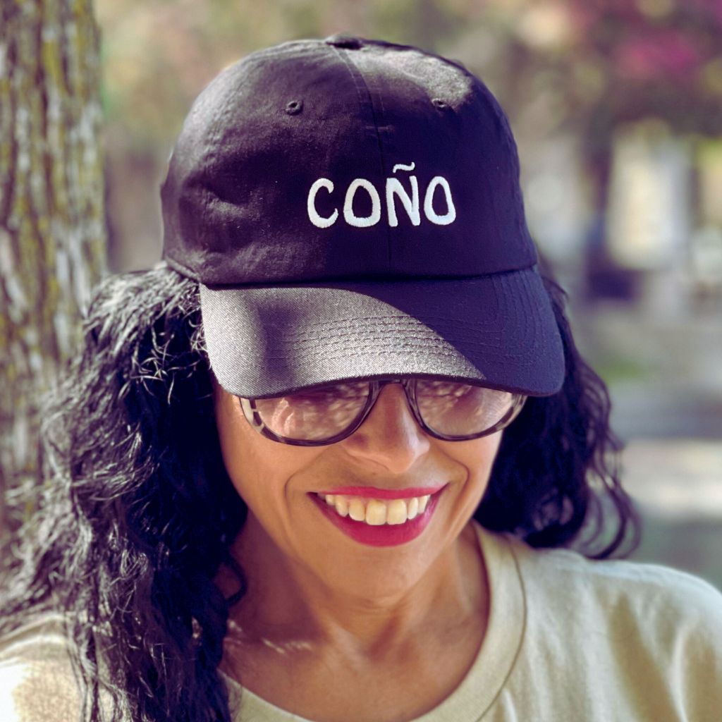 Female wearing a black baseball cap embroidered with Coño - DSY Lifestyle