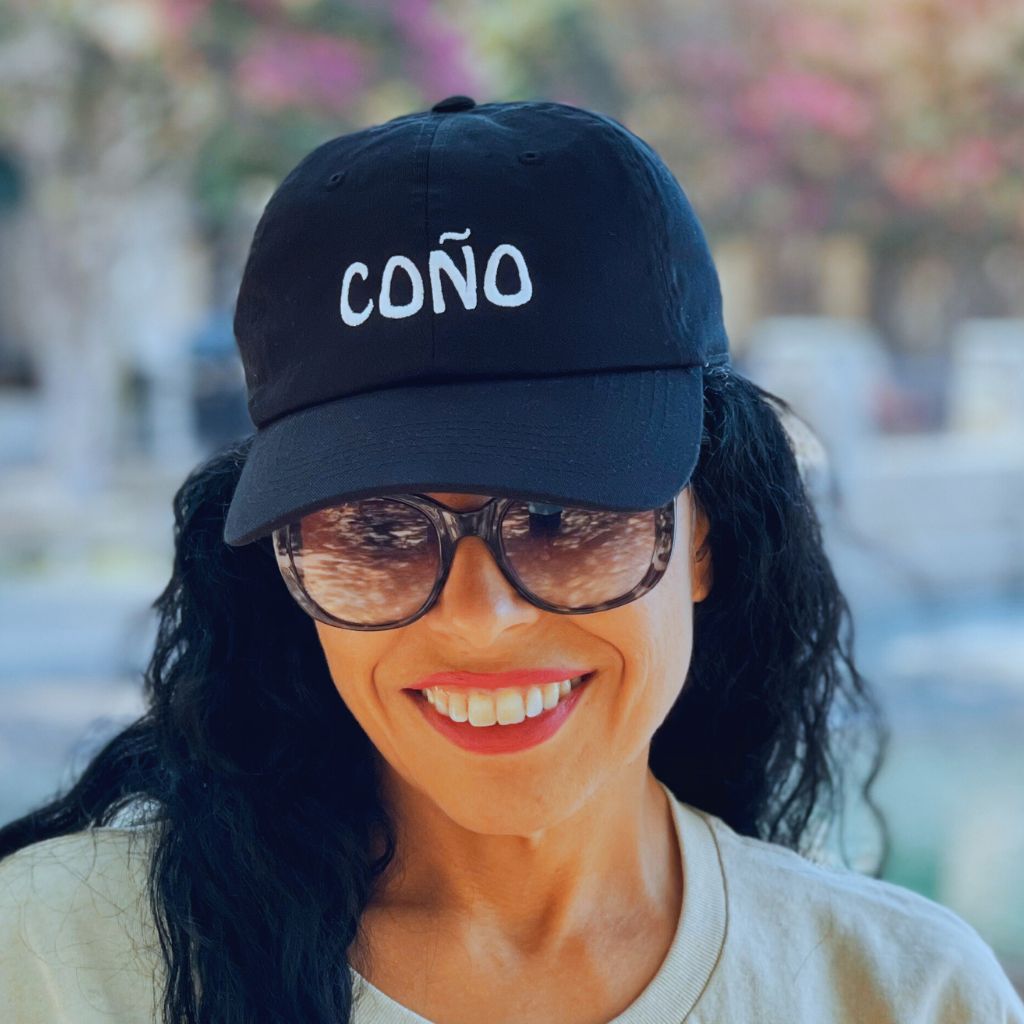 Female wearing a black baseball cap embroidered with Coño - DSY Lifestyle